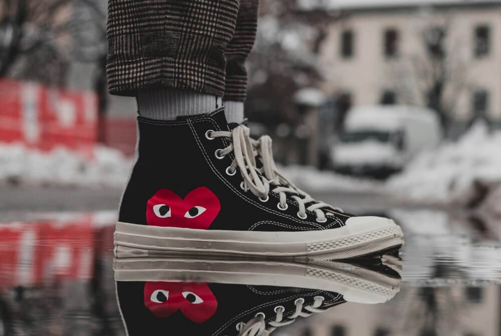 Comme des Garçons sneakers and a wet road