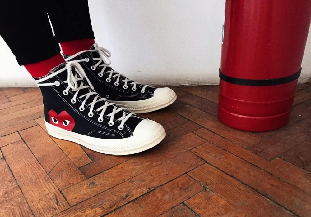 A woman wearing Comme des Garçons sneakers