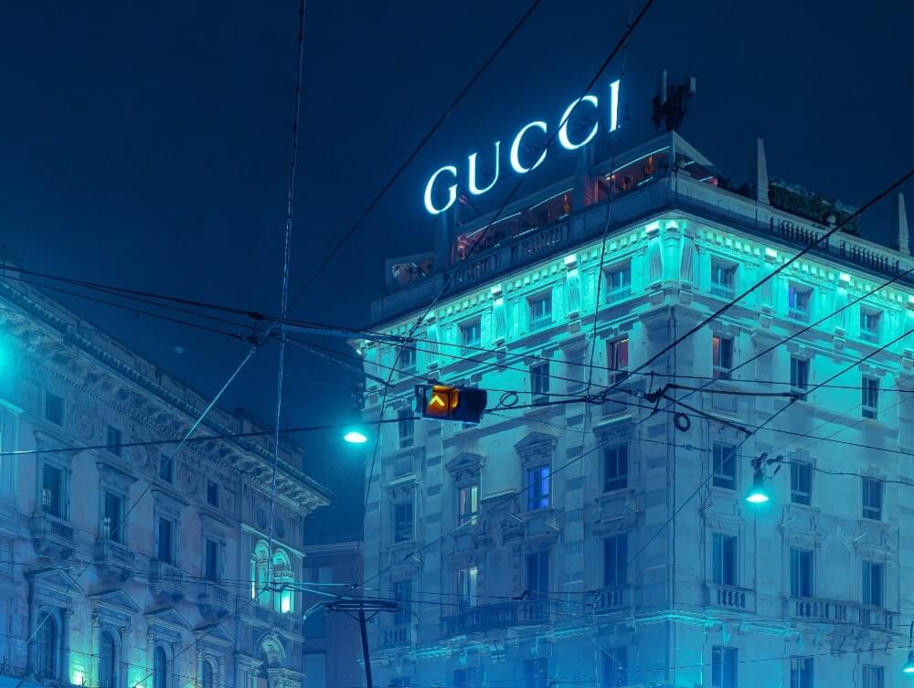 A GUCCI sign glowing at night